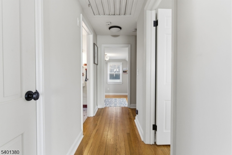 107 Chestnut Street Bound Brook, NJ 08805 - Photo 17 of 24 a view of a hallway with wooden floor and staircase