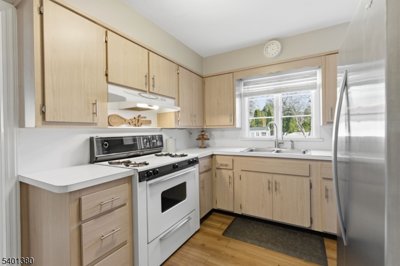 107 Chestnut Street Bound Brook, NJ 08805 - Photo 8 of 24 a kitchen with stainless steel appliances granite countertop a sink a stove and a refrigerator
