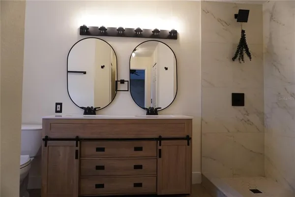 a bathroom with a mirror a sink and a mirror
