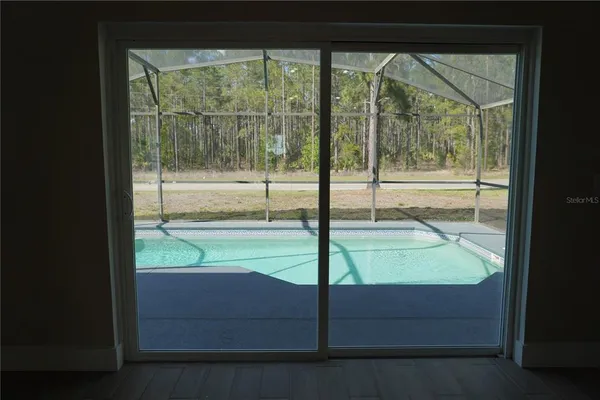 a view of a backyard with swimming pool