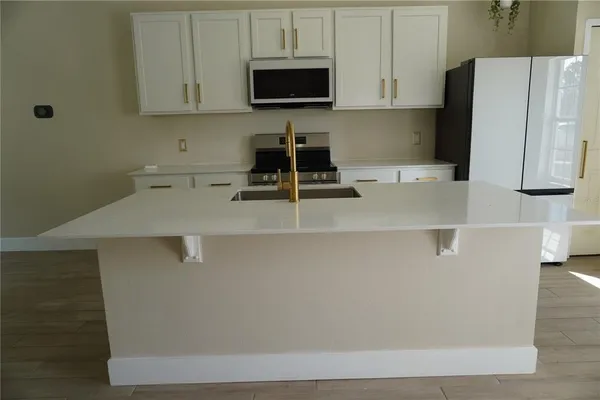 a kitchen with a sink a stove and a refrigerator