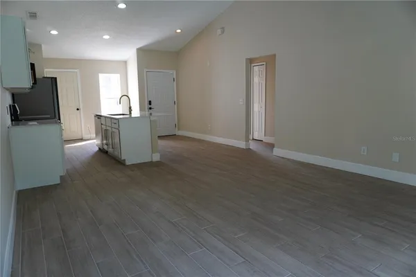 a view of kitchen with cabinets and wooden floor