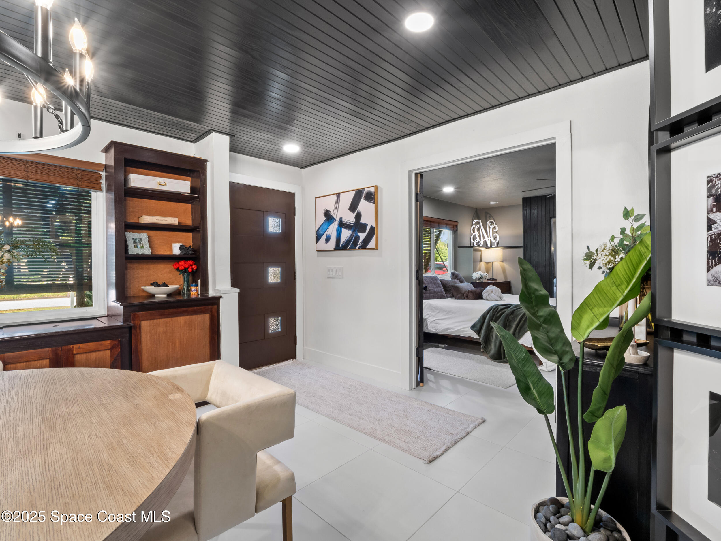 219 Sand Pine Road Indialantic, FL 32903 - Photo 12 of 38 a hallway with furniture and a potted plant
