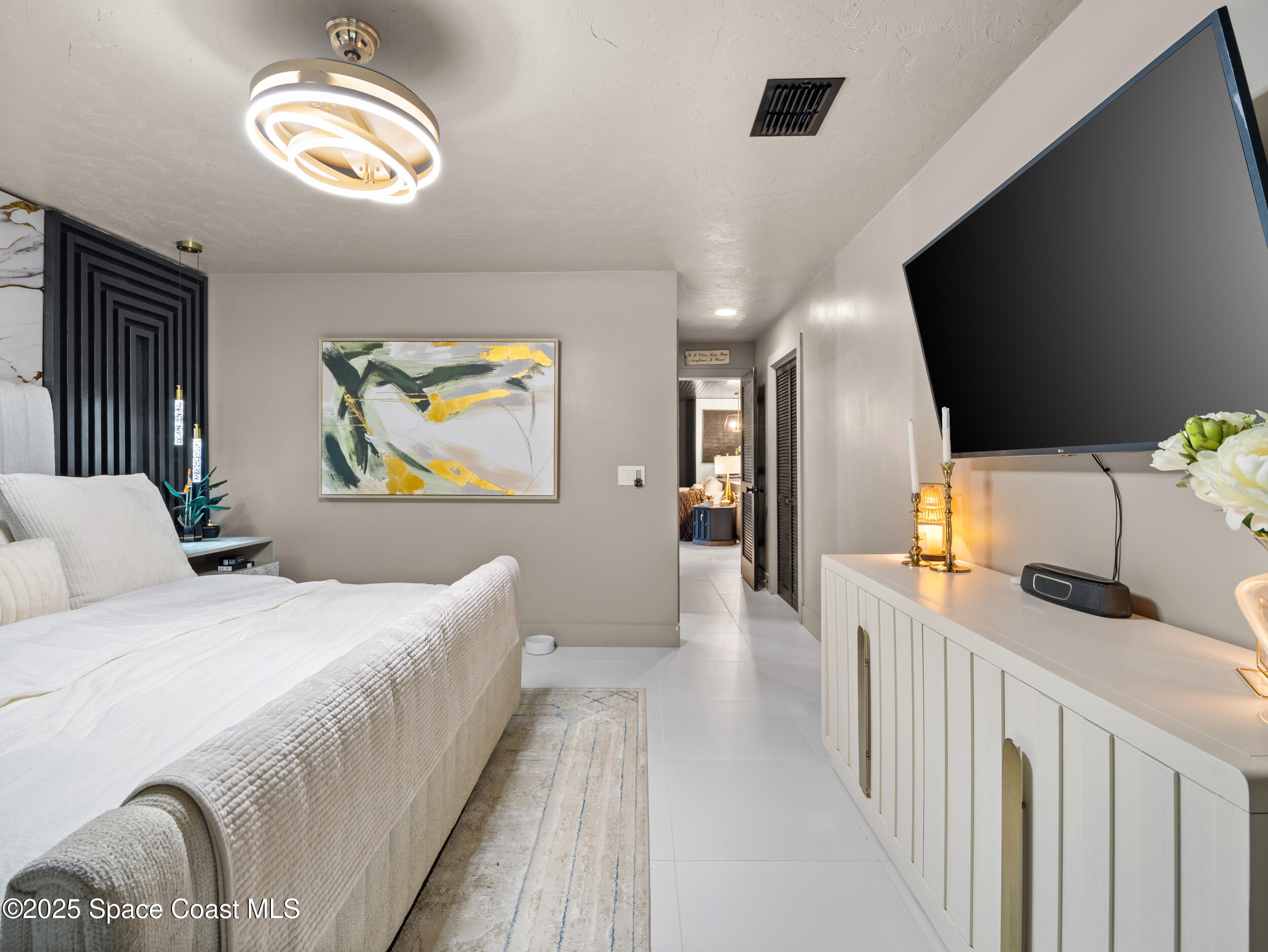 219 Sand Pine Road Indialantic, FL 32903 - Photo 16 of 38 a bedroom with a bed and painting on the wall