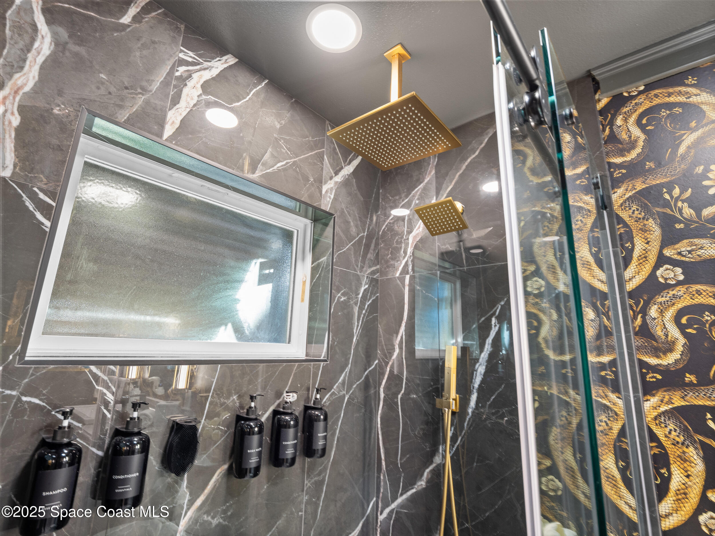 219 Sand Pine Road Indialantic, FL 32903 - Photo 21 of 38 walk in closet with window and chandelier