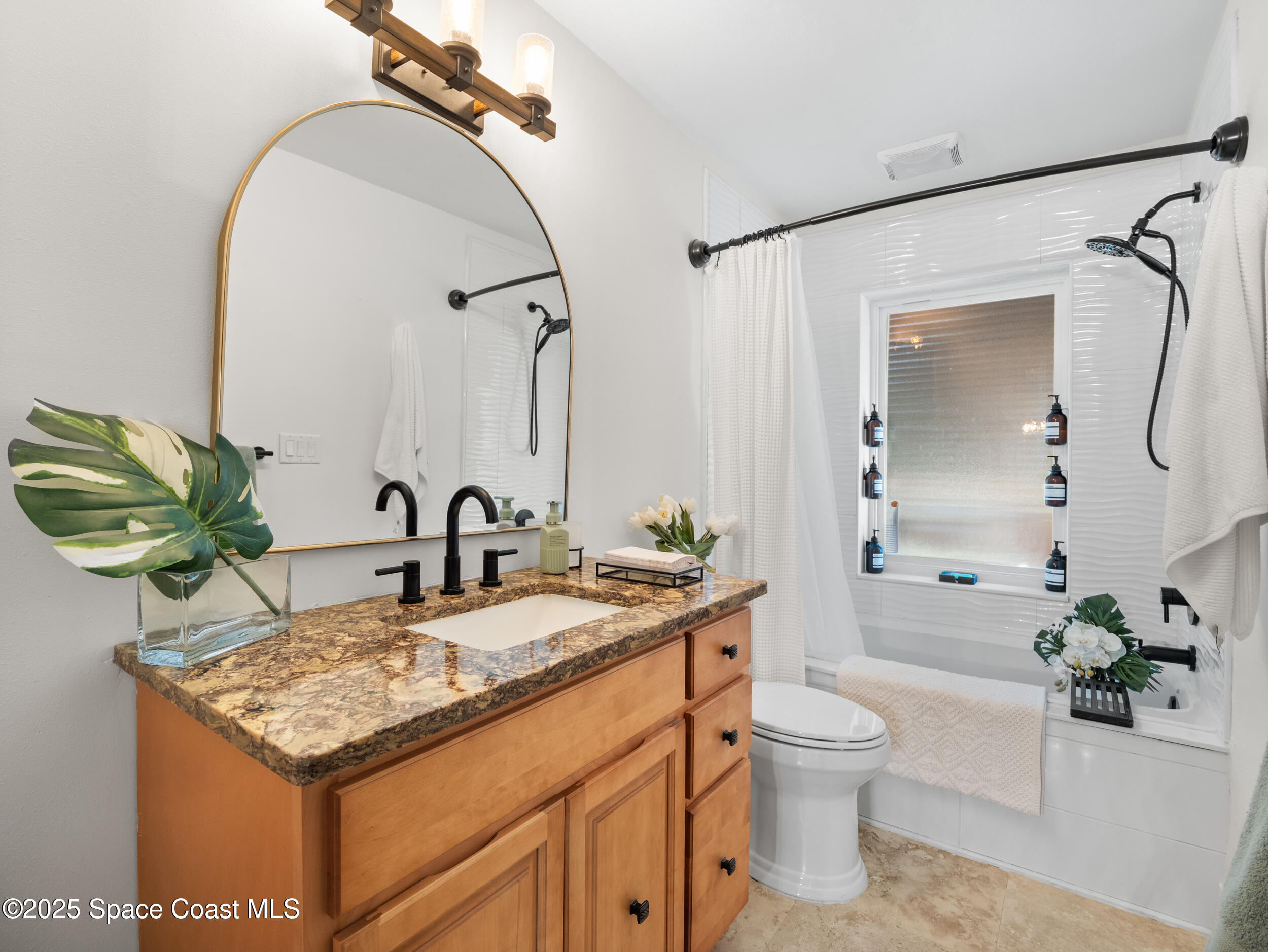 219 Sand Pine Road Indialantic, FL 32903 - Photo 23 of 38 a bathroom with a granite countertop sink a toilet and a mirror