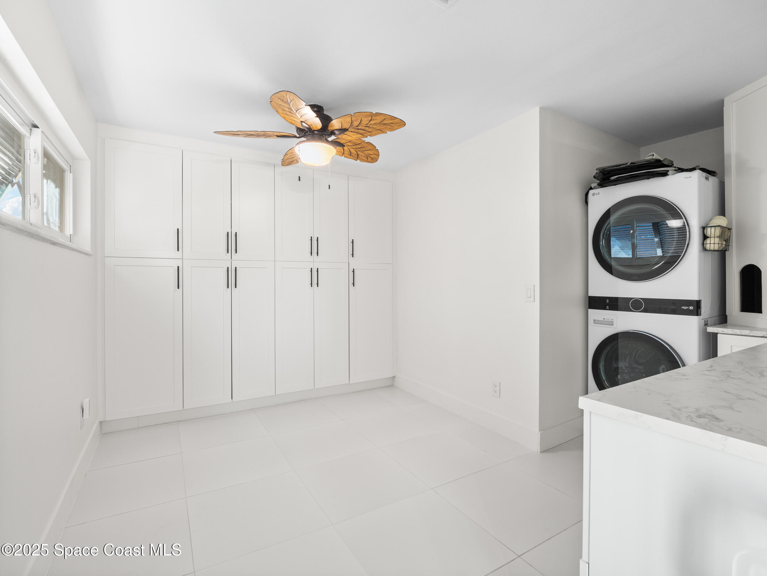 219 Sand Pine Road Indialantic, FL 32903 - Photo 25 of 38 a view of a livingroom with a washer and dryer
