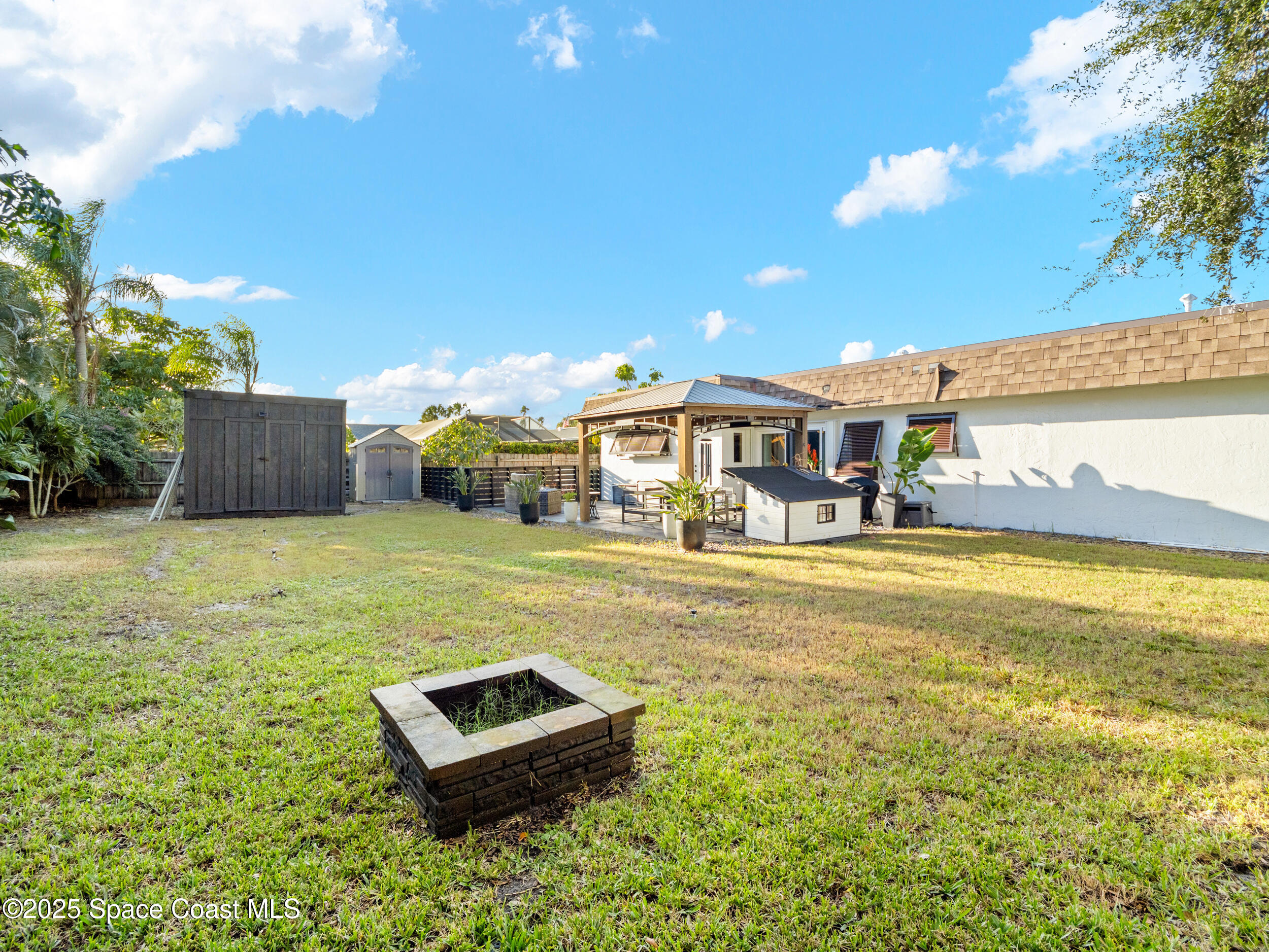 219 Sand Pine Road Indialantic, FL 32903 - Photo 27 of 38 a view of a house with a big yard