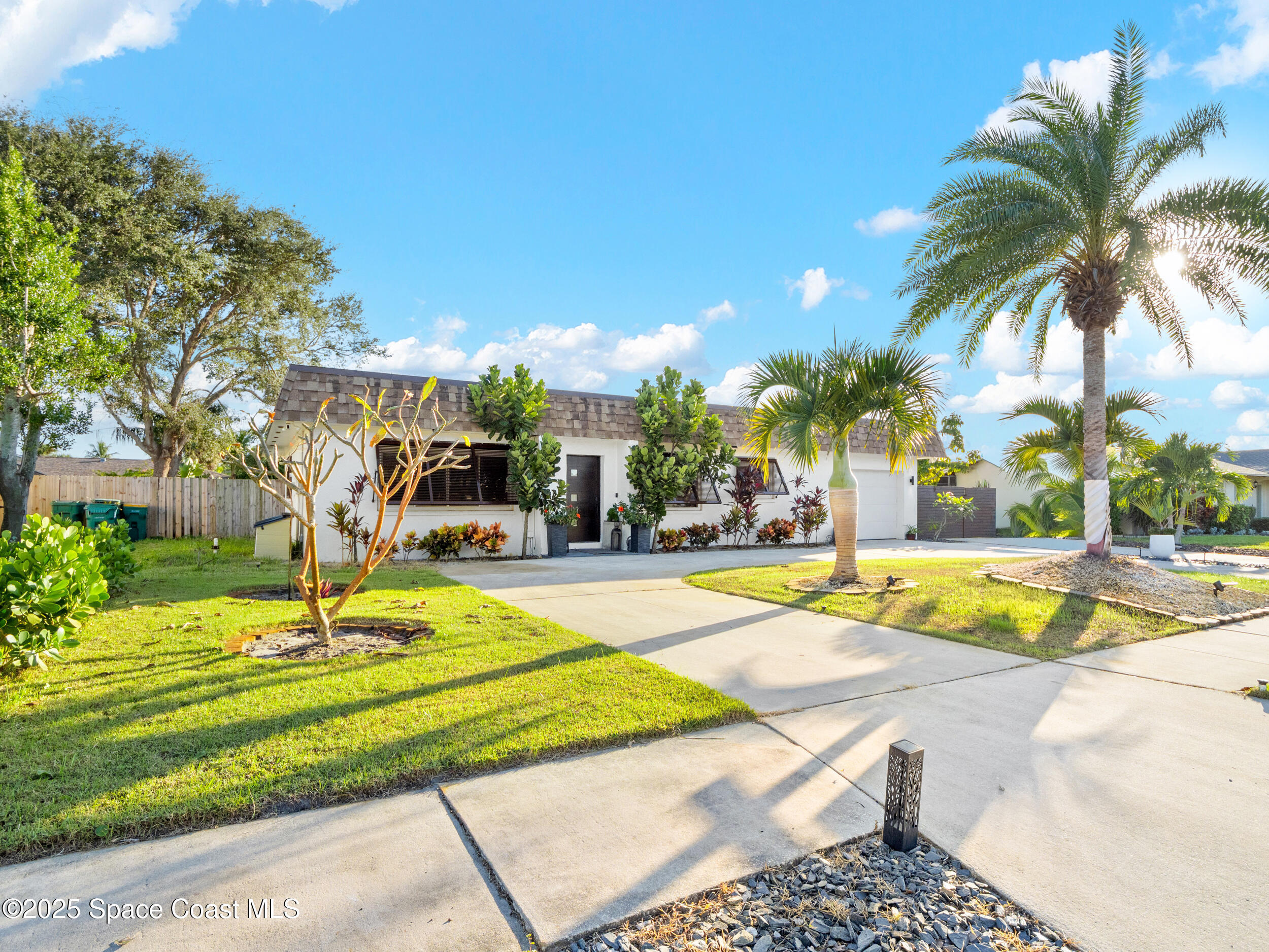 219 Sand Pine Road Indialantic, FL 32903 - Photo 30 of 38 a swimming pool with outdoor seating and yard