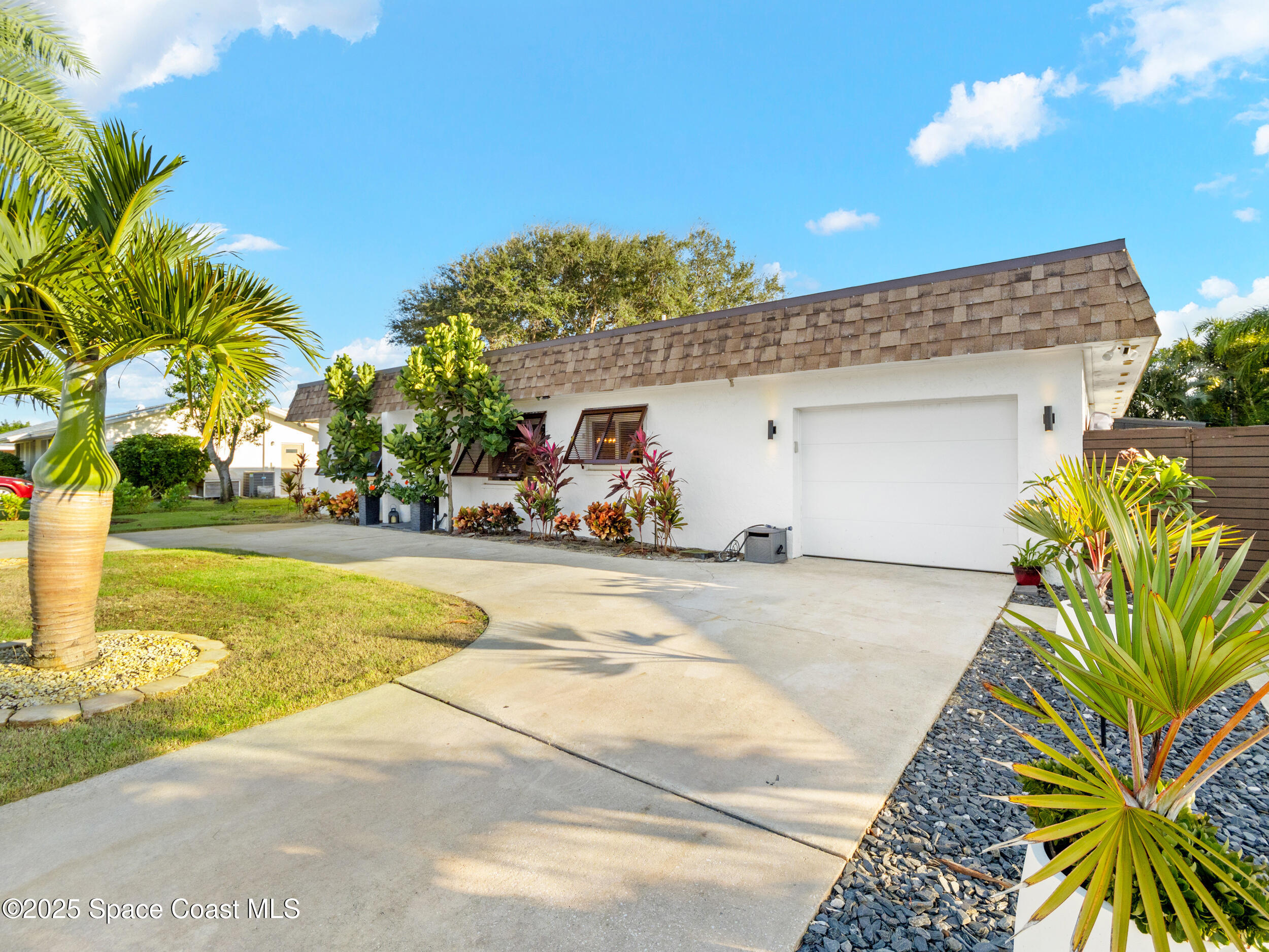 219 Sand Pine Road Indialantic, FL 32903 - Photo 31 of 38 a view of a swimming pool with some potted plants
