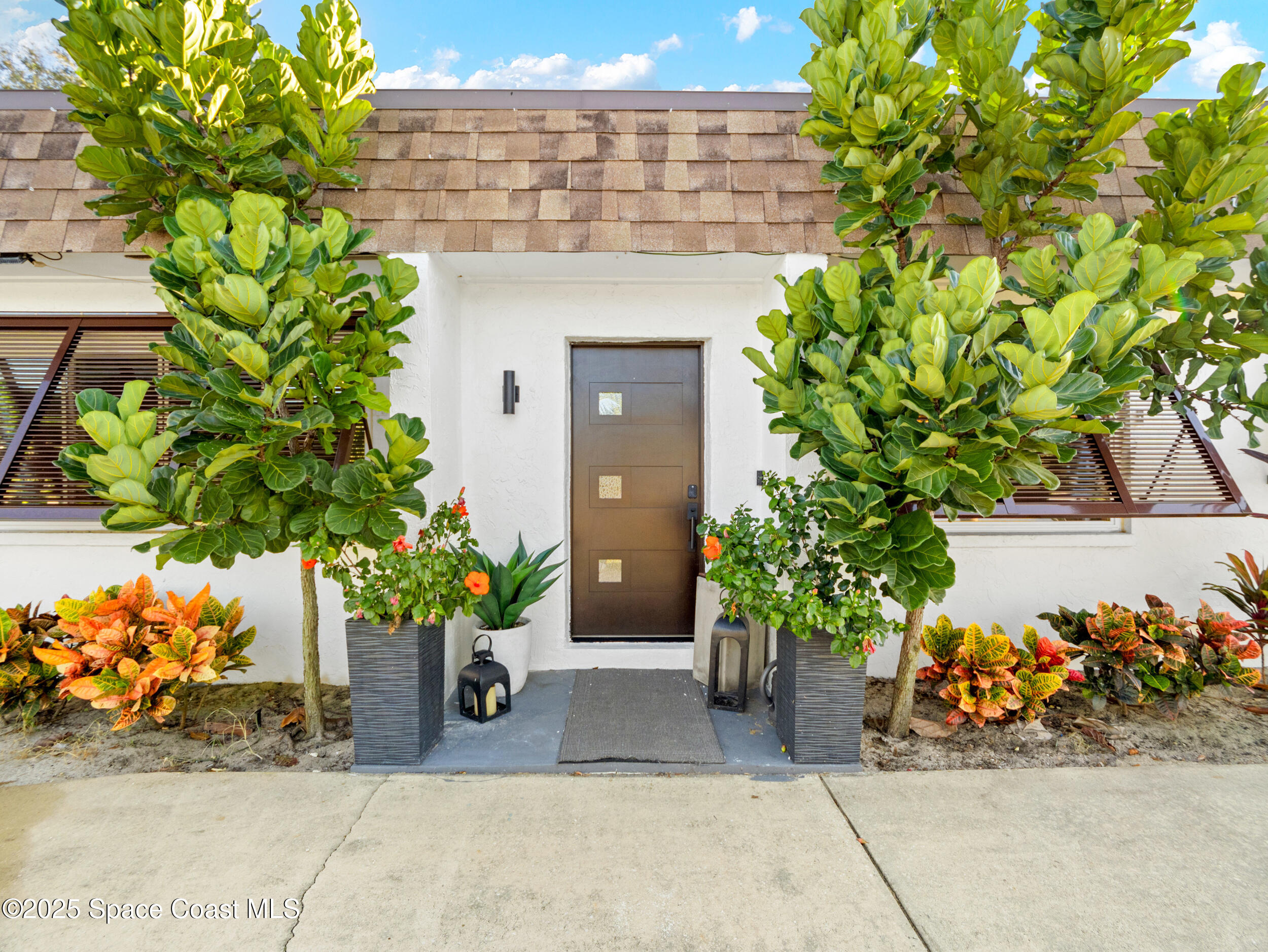 219 Sand Pine Road Indialantic, FL 32903 - Photo 32 of 38 a potted plant sitting in front of a building