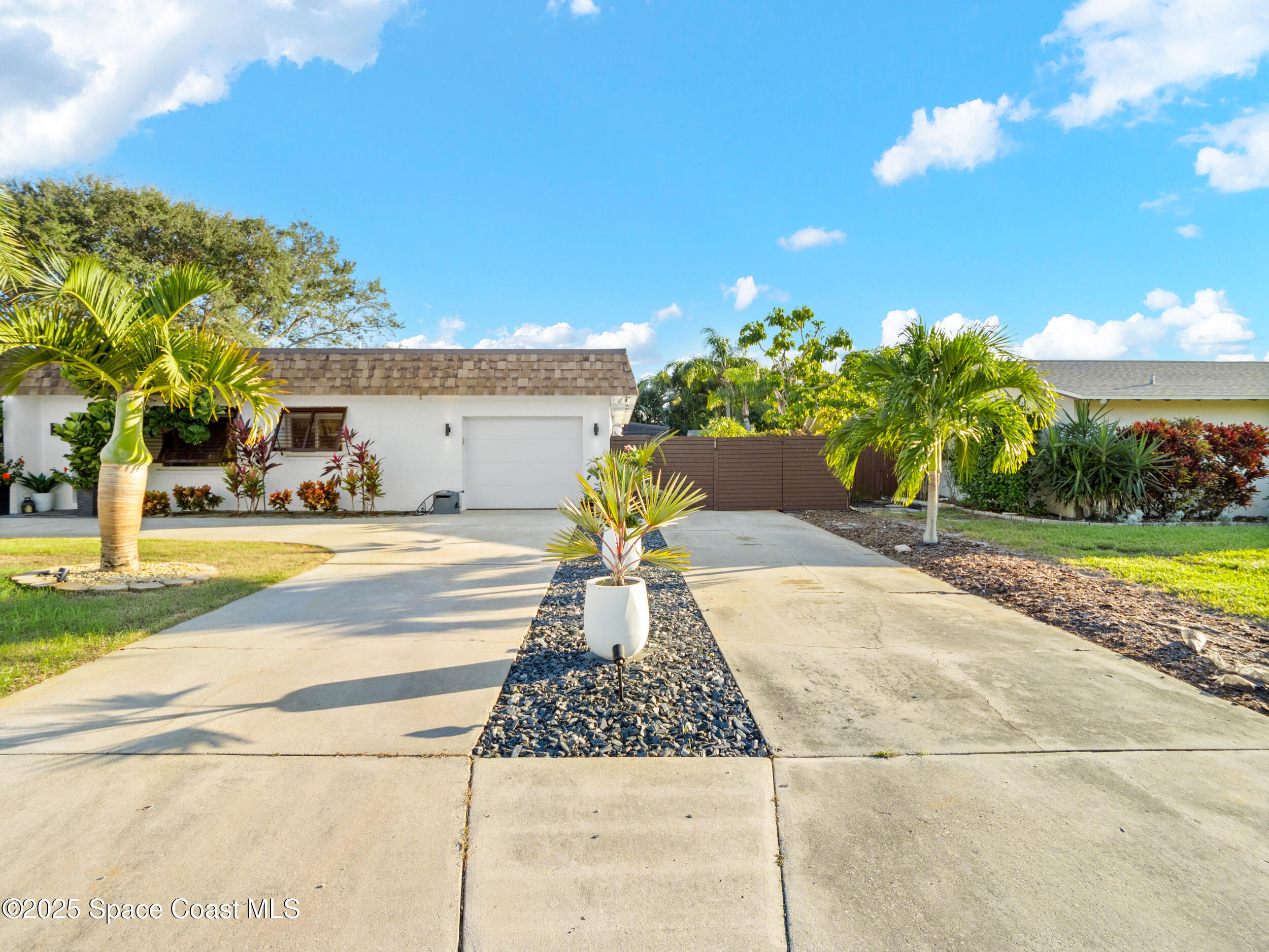 219 Sand Pine Road Indialantic, FL 32903 - Photo 33 of 38 a view of yellow house with a yard