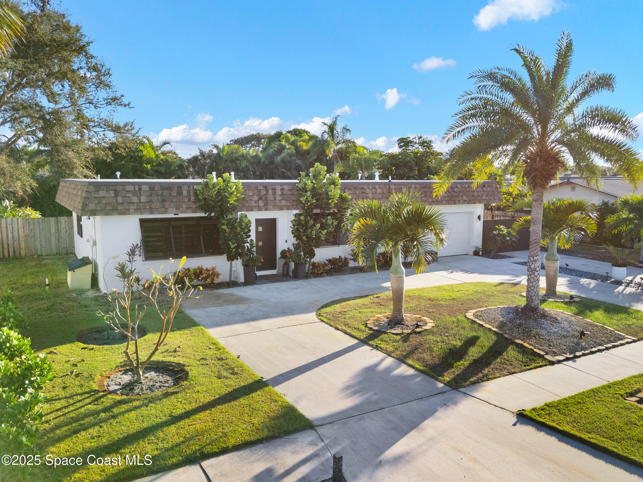 219 Sand Pine Road Indialantic, FL 32903 - Photo 5 of 38 a swimming pool with some trees in the background