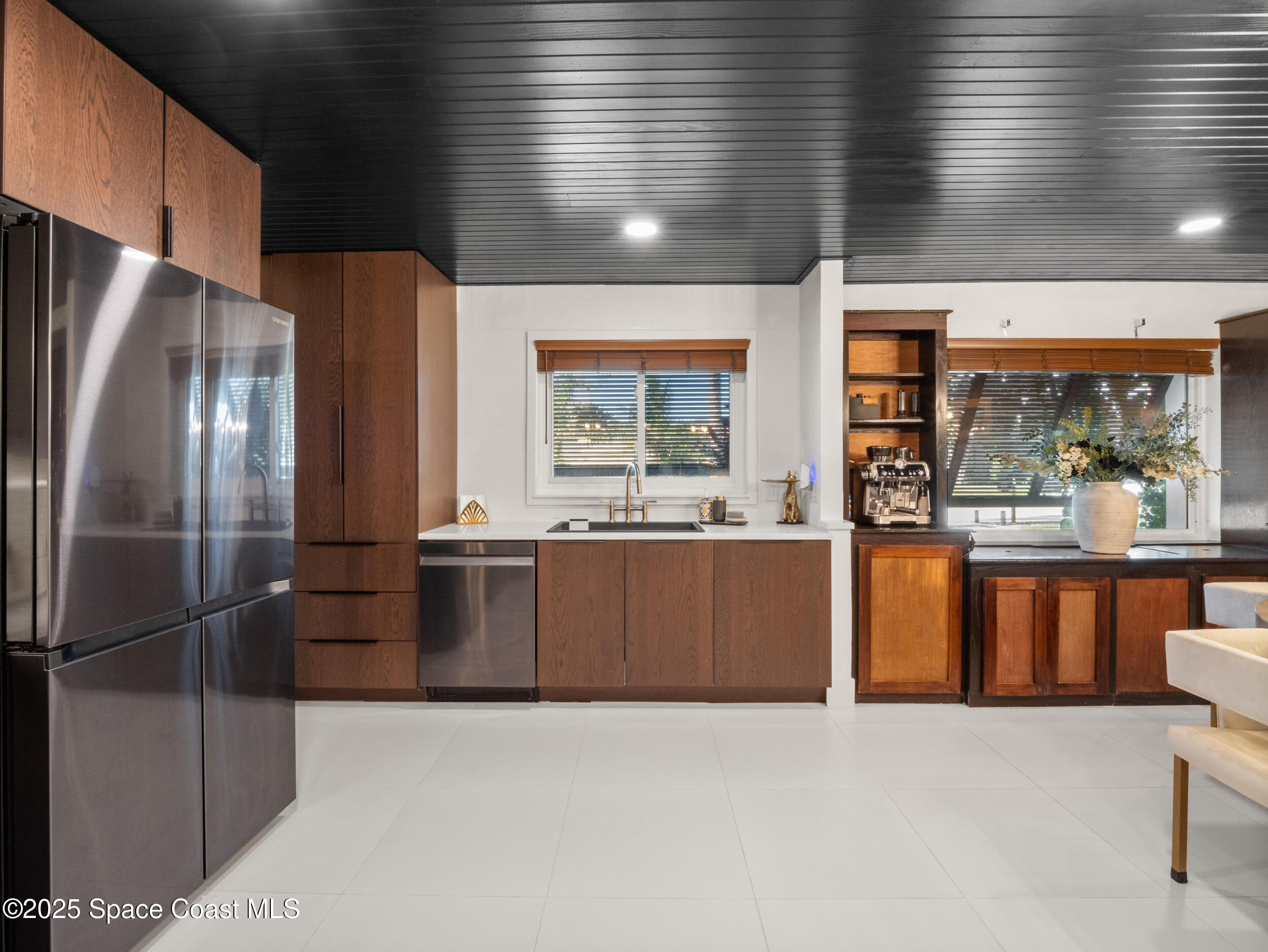 219 Sand Pine Road Indialantic, FL 32903 - Photo 6 of 38 a large kitchen with stainless steel appliances kitchen island granite countertop a refrigerator a sink and a stove