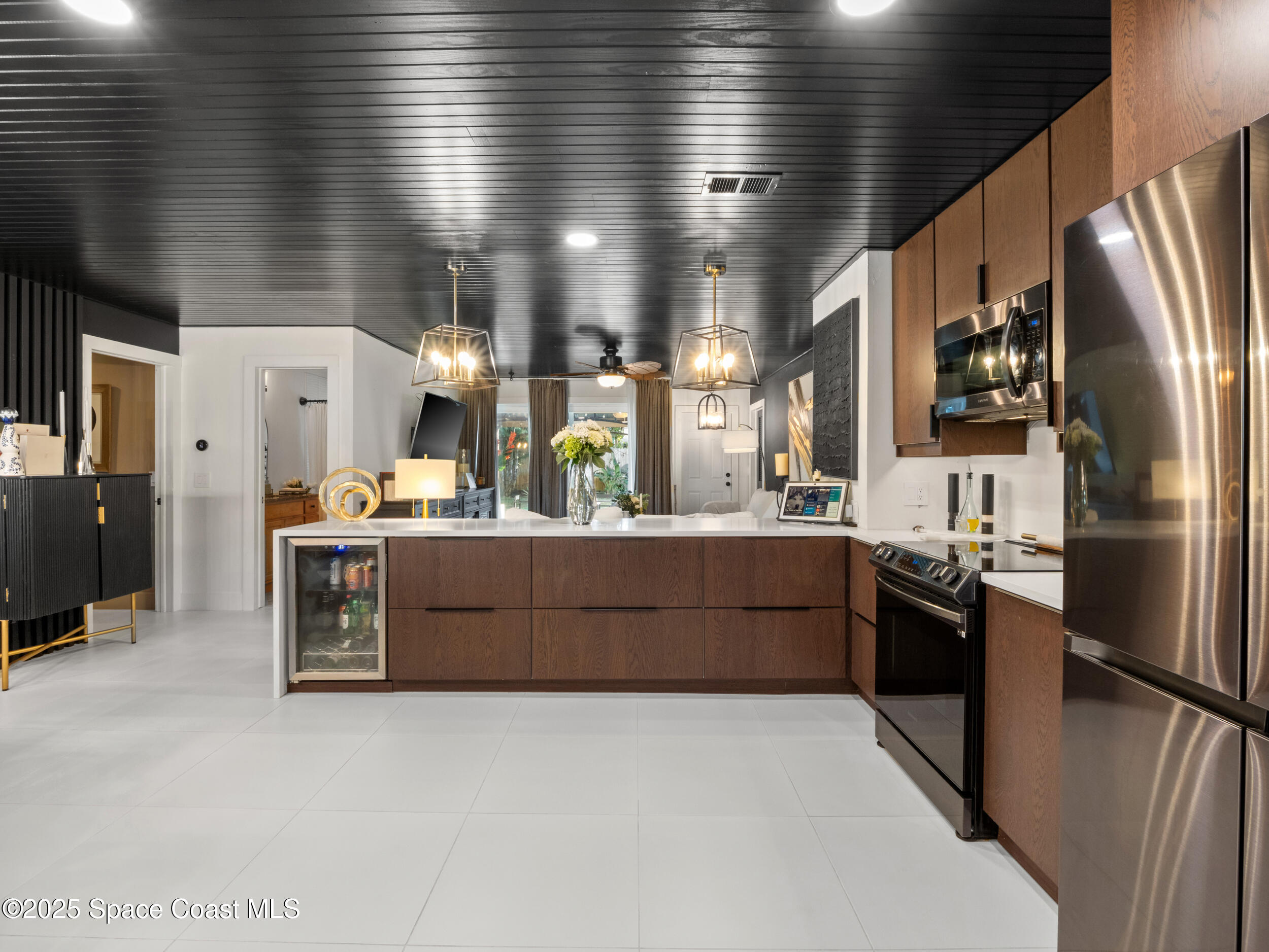 219 Sand Pine Road Indialantic, FL 32903 - Photo 8 of 38 a kitchen with stainless steel appliances kitchen island granite countertop a refrigerator a sink a stove and dishwasher