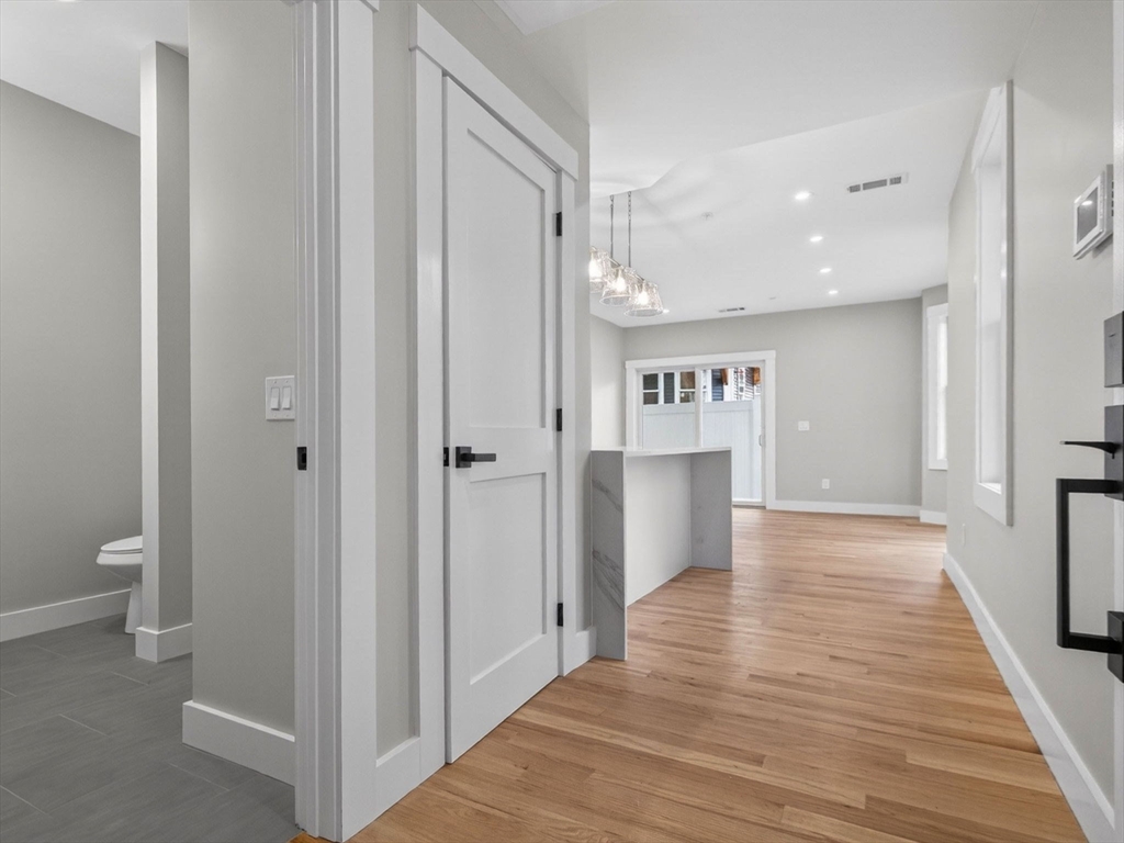 60 Stanley Street, Unit 102 Boston, MA 02125 - Photo 12 of 15 a view of a hallway with wooden floor