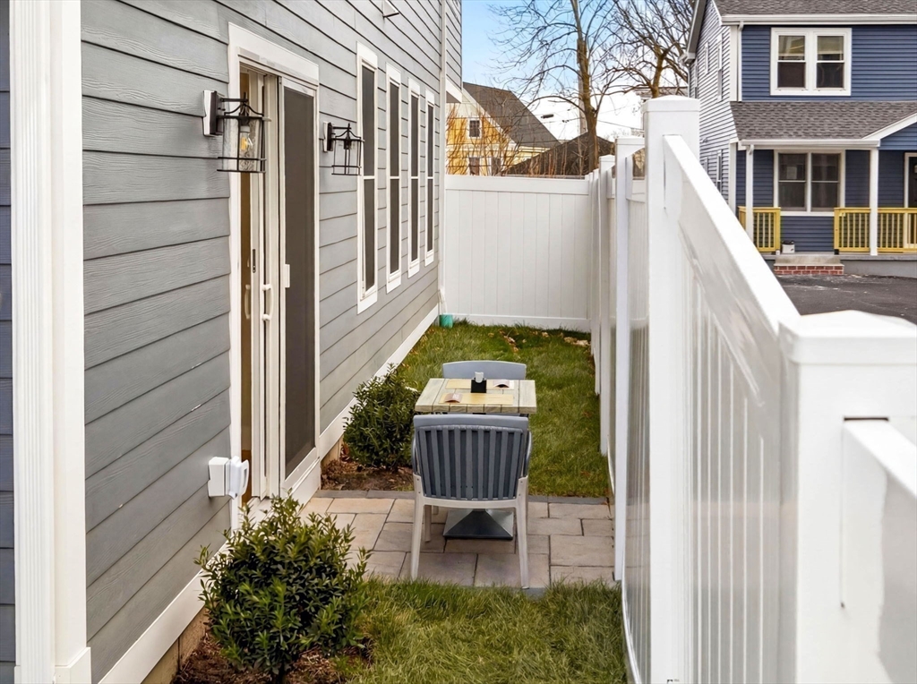 60 Stanley Street, Unit 102 Boston, MA 02125 - Photo 14 of 15 a backyard of a house with outdoor seating