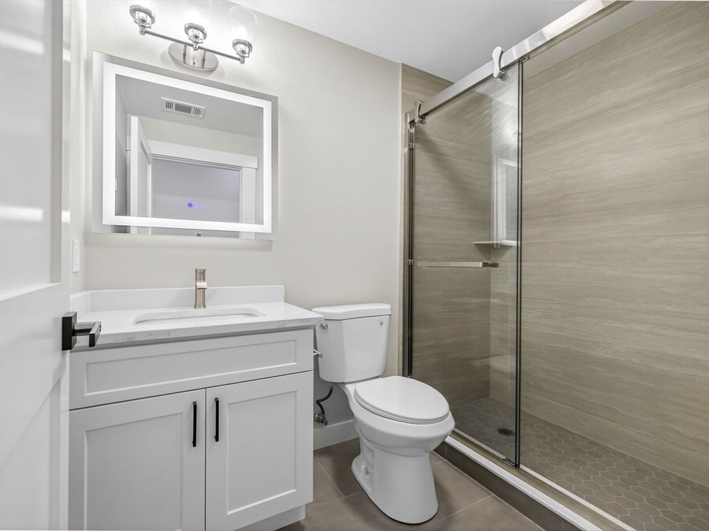 60 Stanley Street, Unit 102 Boston, MA 02125 - Photo 9 of 15 a bathroom with a sink toilet and shower