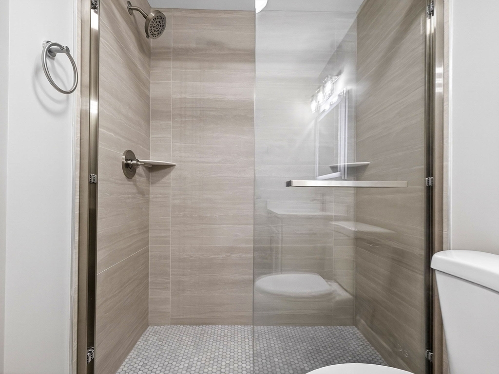 60 Stanley Street, Unit 102 Boston, MA 02125 - Photo 10 of 15 a bathroom with a shower a toilet and sink
