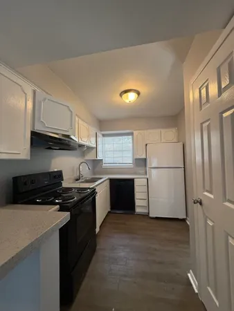 a bathroom with a granite countertop sink a mirror and a shower