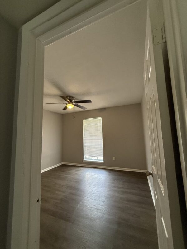 603 East 29th Street, Unit 4 Bryan, TX 77803 - Photo 6 of 6 an empty room with wooden floor and windows