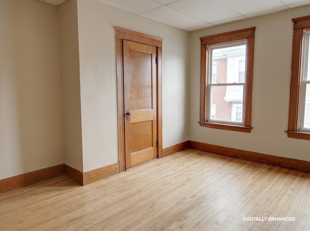35 Windham Street Worcester, MA 01610 - Photo 14 of 39 an empty room with wooden floor and windows