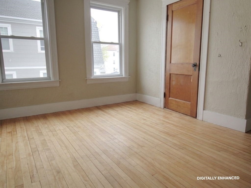 35 Windham Street Worcester, MA 01610 - Photo 15 of 39 an empty room with wooden floor and windows