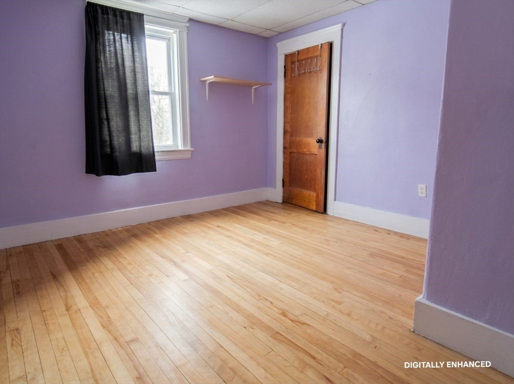 35 Windham Street Worcester, MA 01610 - Photo 16 of 39 a view of an empty room with wooden floor and a window