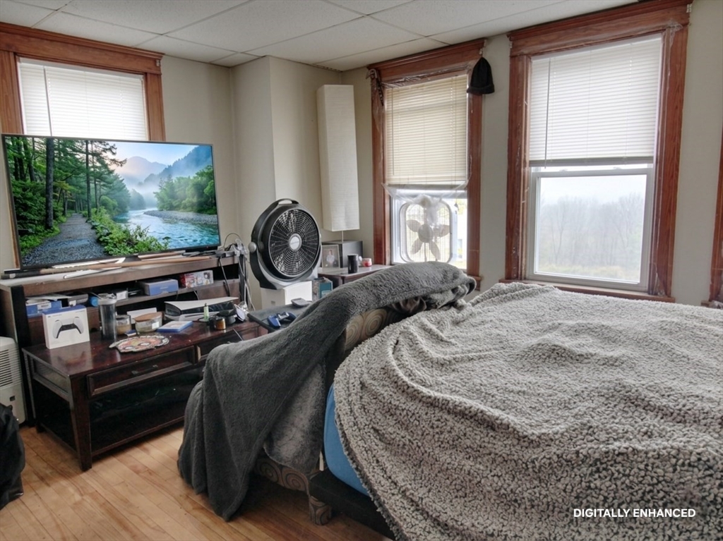 35 Windham Street Worcester, MA 01610 - Photo 20 of 39 a bedroom with a bed a mirror and a large window
