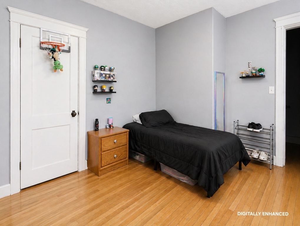 35 Windham Street Worcester, MA 01610 - Photo 28 of 39 a bedroom with a bed and wooden floor