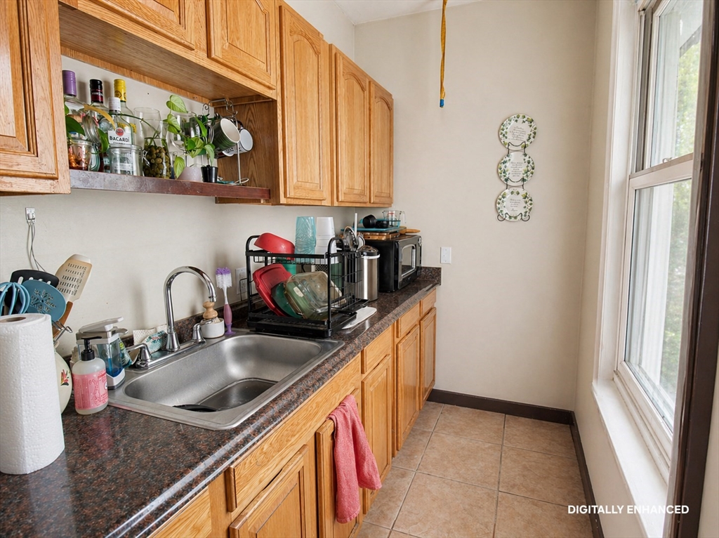 35 Windham Street Worcester, MA 01610 - Photo 29 of 39 a kitchen with stainless steel appliances granite countertop a sink a stove and a wooden cabinets