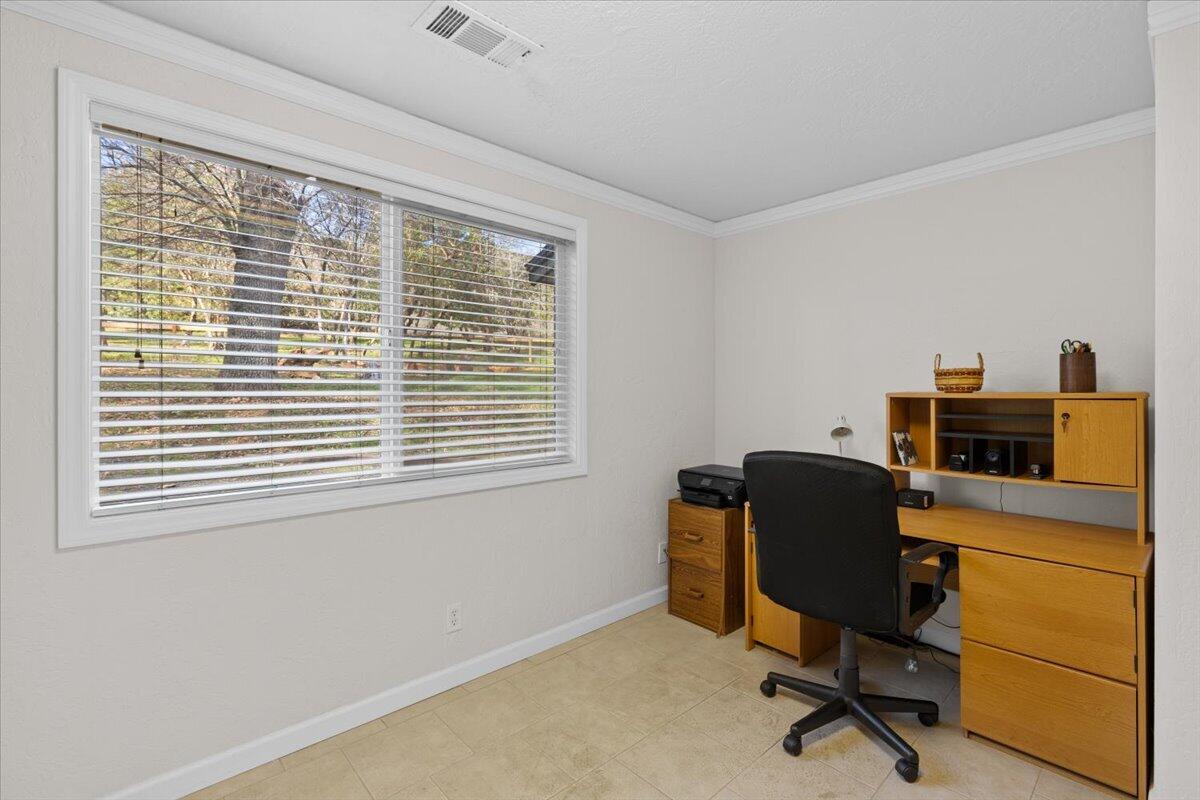 324 China Gulch Road Jacksonville, OR 97530 - Photo 18 of 45 a view of a workspace with furniture and a window