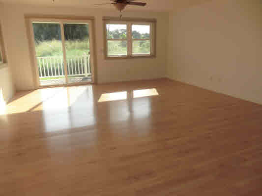 1736 Hulu Road, Unit 2 Kapaa, HI 96746 - Photo 5 of 12 an empty room with wooden floor and windows