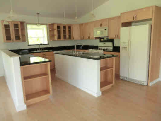 1736 Hulu Road, Unit 2 Kapaa, HI 96746 - Photo 6 of 12 a kitchen with granite countertop a refrigerator and a sink