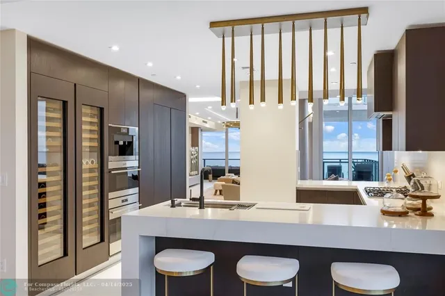 a kitchen with a table chairs refrigerator and cabinets