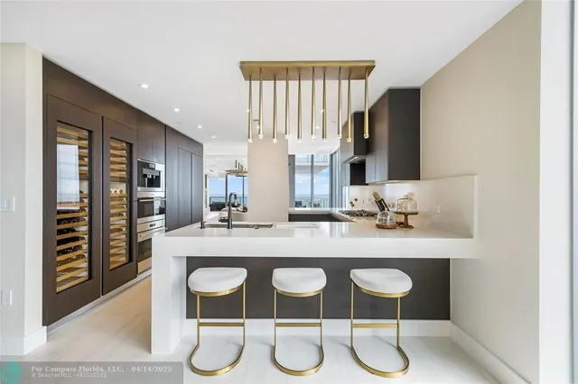 a kitchen with a sink stainless steel appliances and cabinets