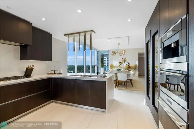 a kitchen with stainless steel appliances a stove a sink and a refrigerator