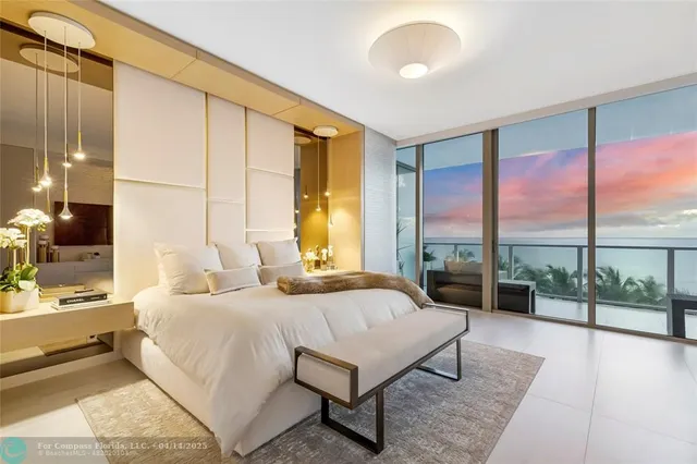 a bedroom with a large bed and a large window