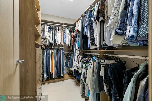 a bedroom with a large bed and a potted plant