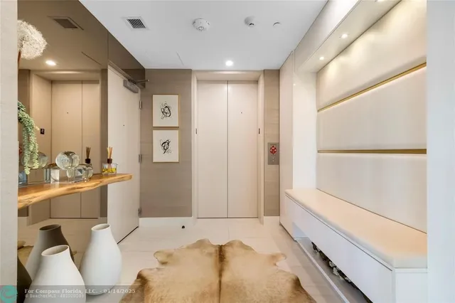 a large bedroom with a large bed and chandelier