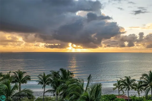 a living room filled with furniture and a chandelier