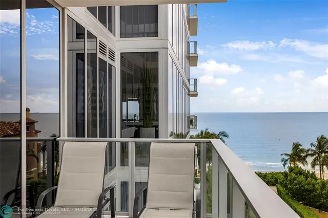 a view of swimming pool with sitting area and lake view