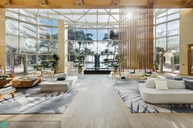 a view of a hallway with wooden floor and a bathroom