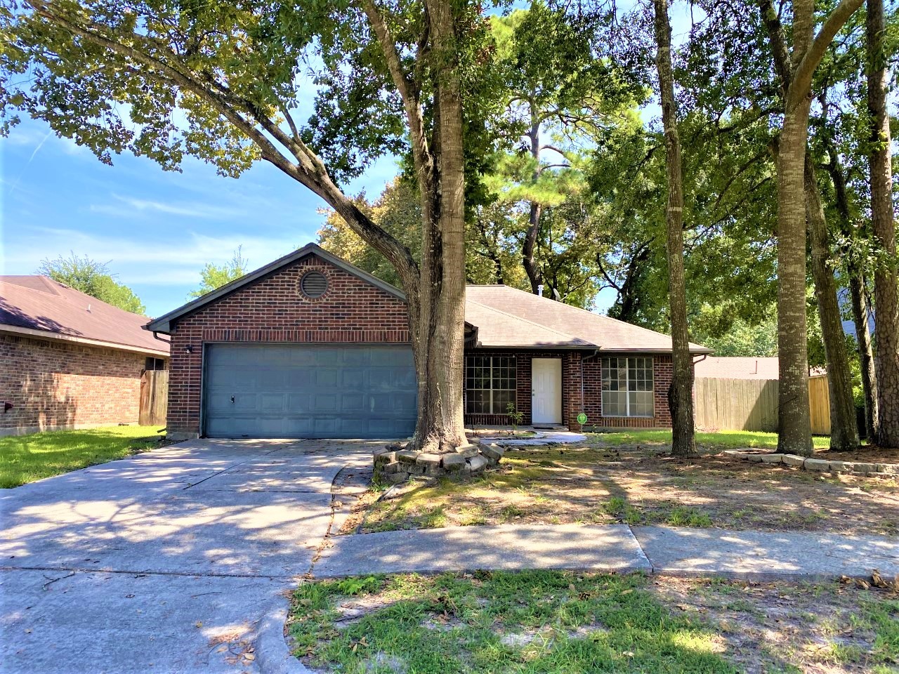 3011 Pheasant Run Humble, TX 77396 - Photo 1 of 17 a front view of a house with a yard and large tree