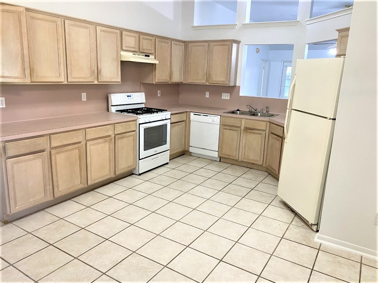 3011 Pheasant Run Humble, TX 77396 - Photo 2 of 17 a kitchen with a white cabinets and white appliances