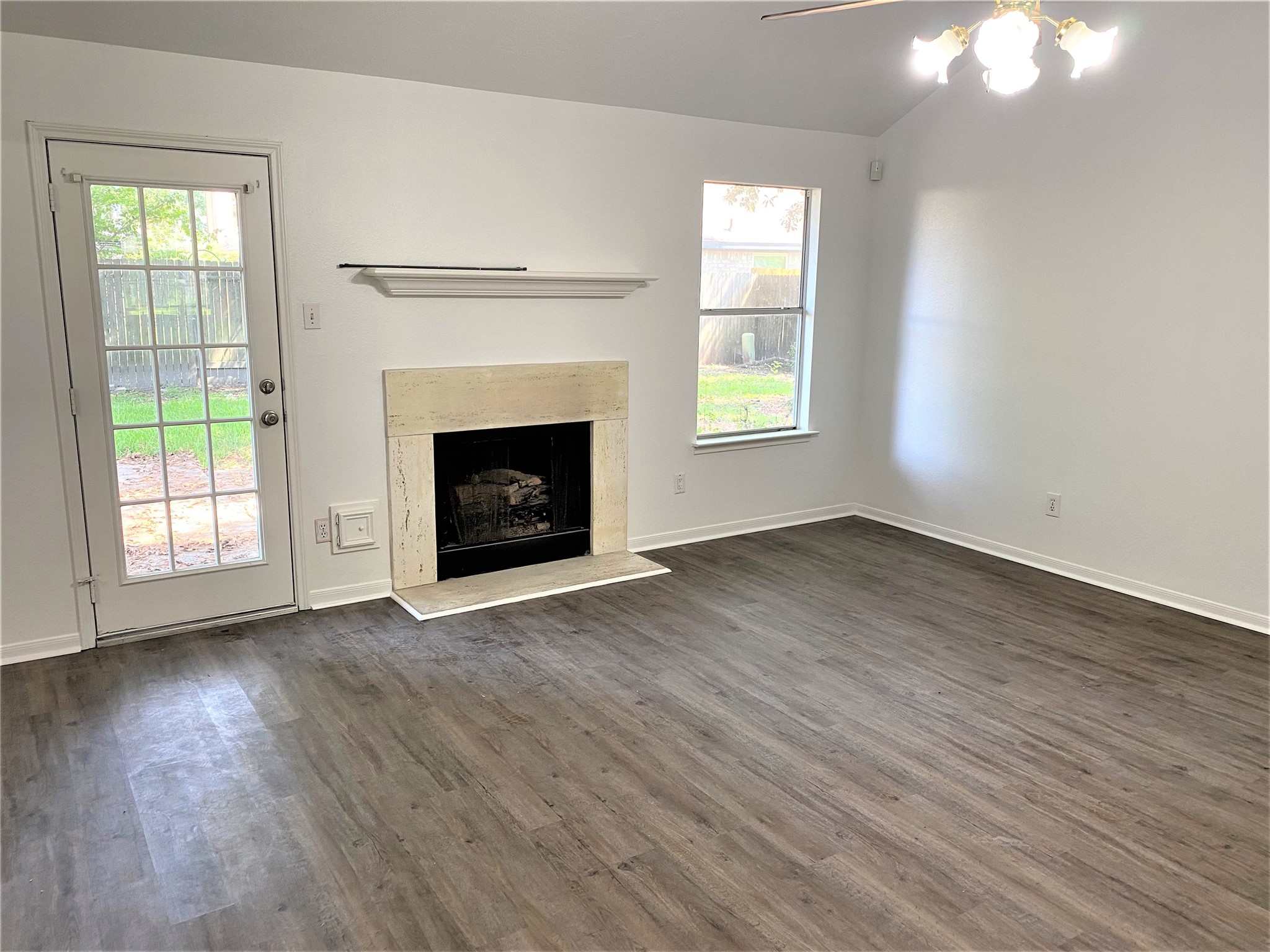 3011 Pheasant Run Humble, TX 77396 - Photo 5 of 17 an empty room with wooden floor fireplace and windows