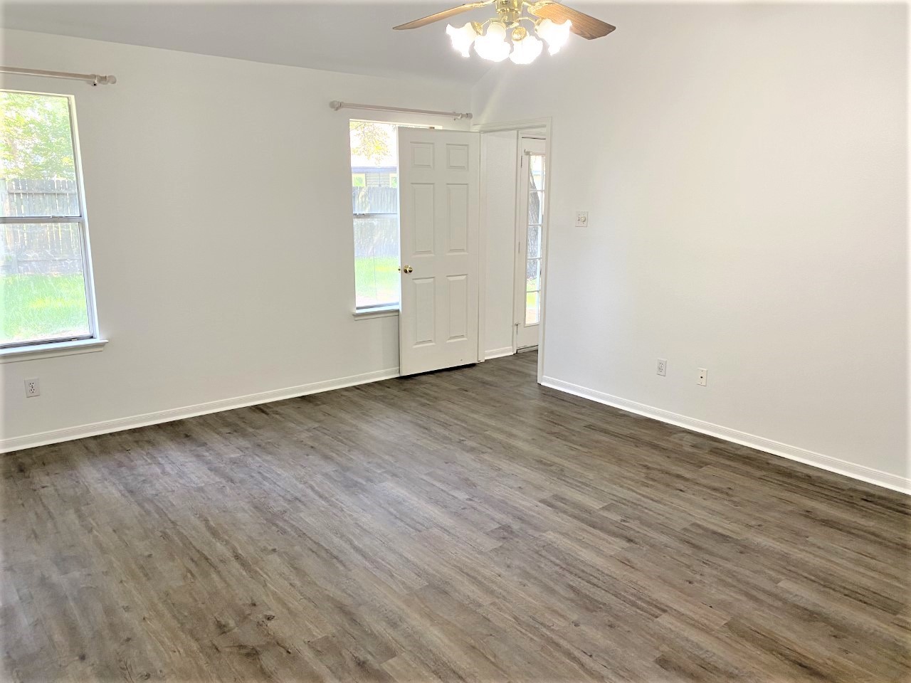 3011 Pheasant Run Humble, TX 77396 - Photo 7 of 17 an empty room with wooden floor and windows