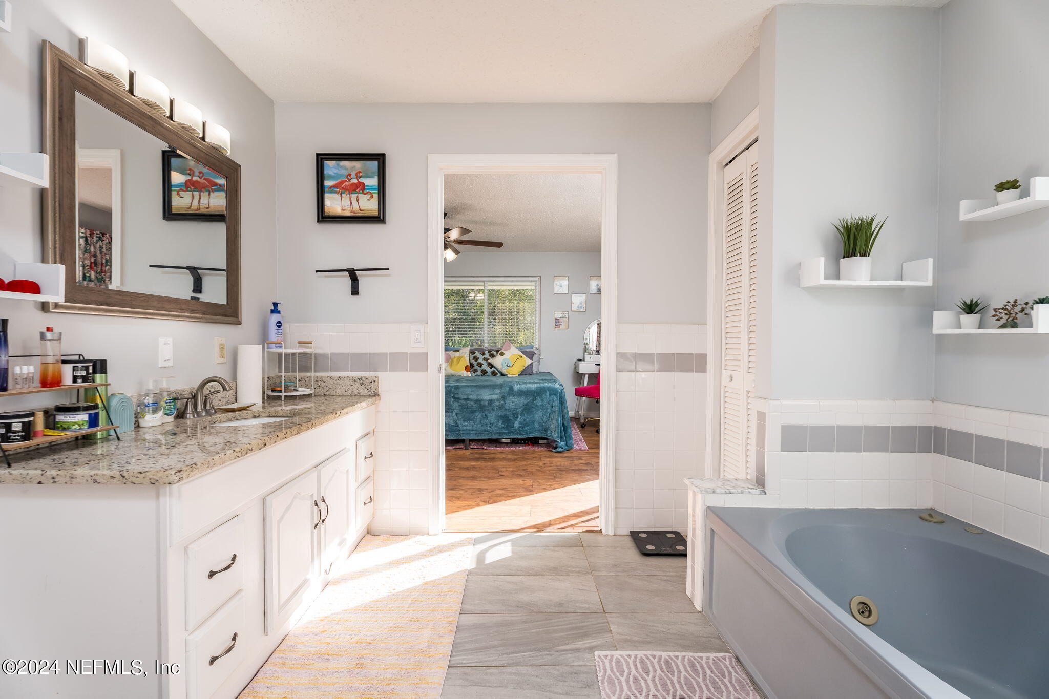 320 Katnack Road St. Augustine, FL 32095 - Photo 22 of 33 a bathroom with a granite countertop tub sink and mirror