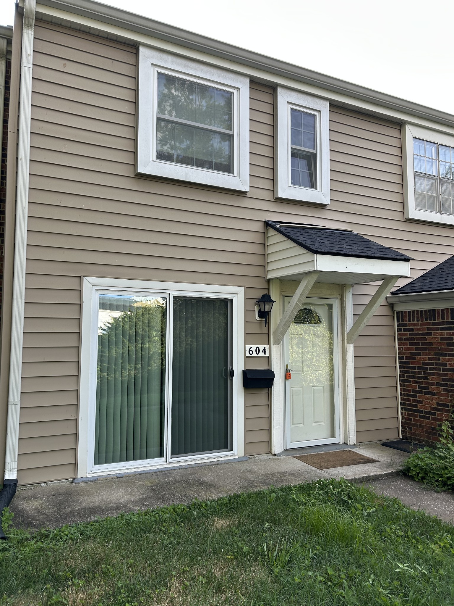 604 Granville Road, Unit 604 Franklin, TN 37064 - Photo 4 of 24 a front view of a house with a yard and garage