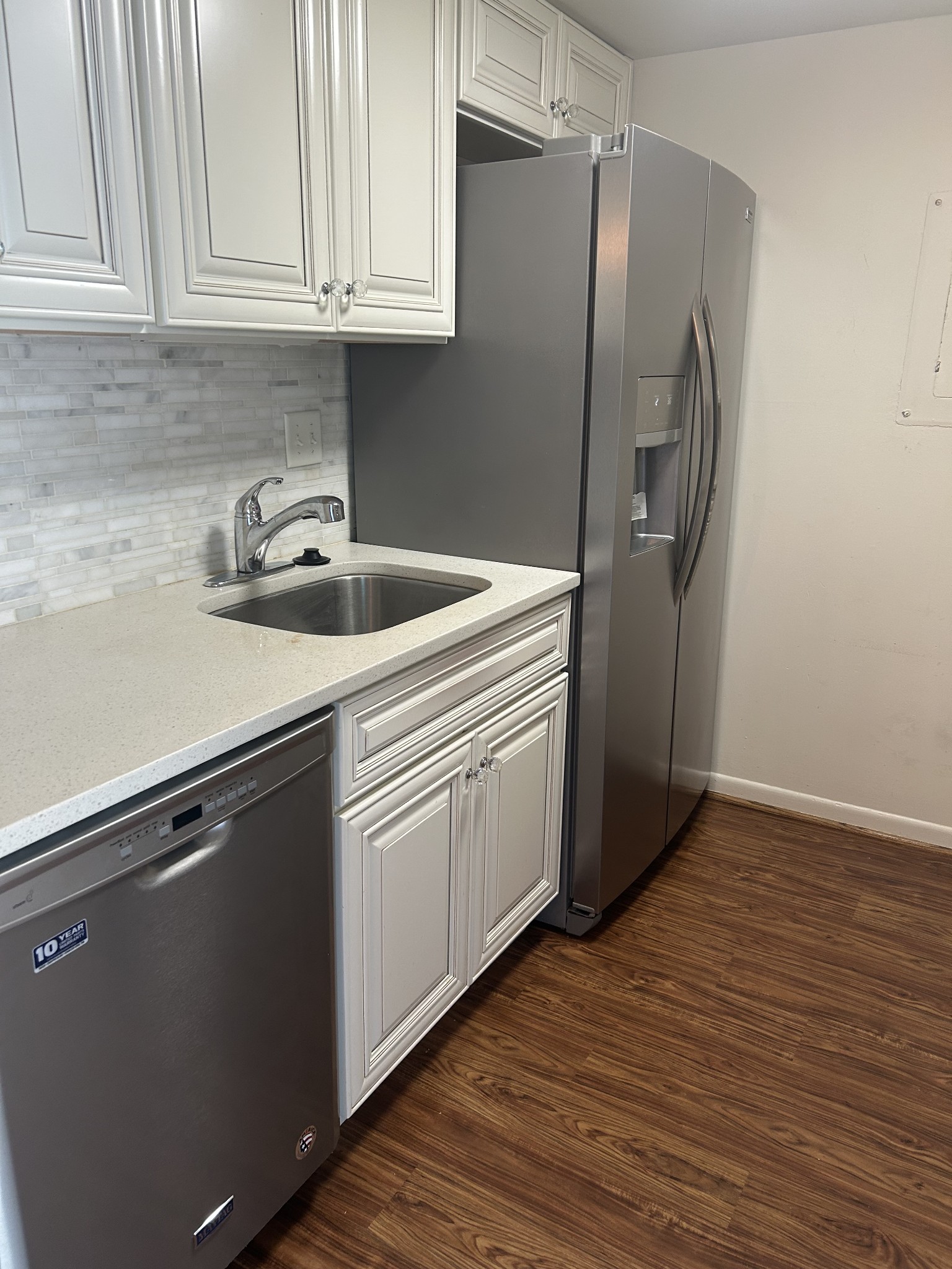 604 Granville Road, Unit 604 Franklin, TN 37064 - Photo 6 of 24 a kitchen with stainless steel appliances granite countertop a refrigerator sink and cabinets